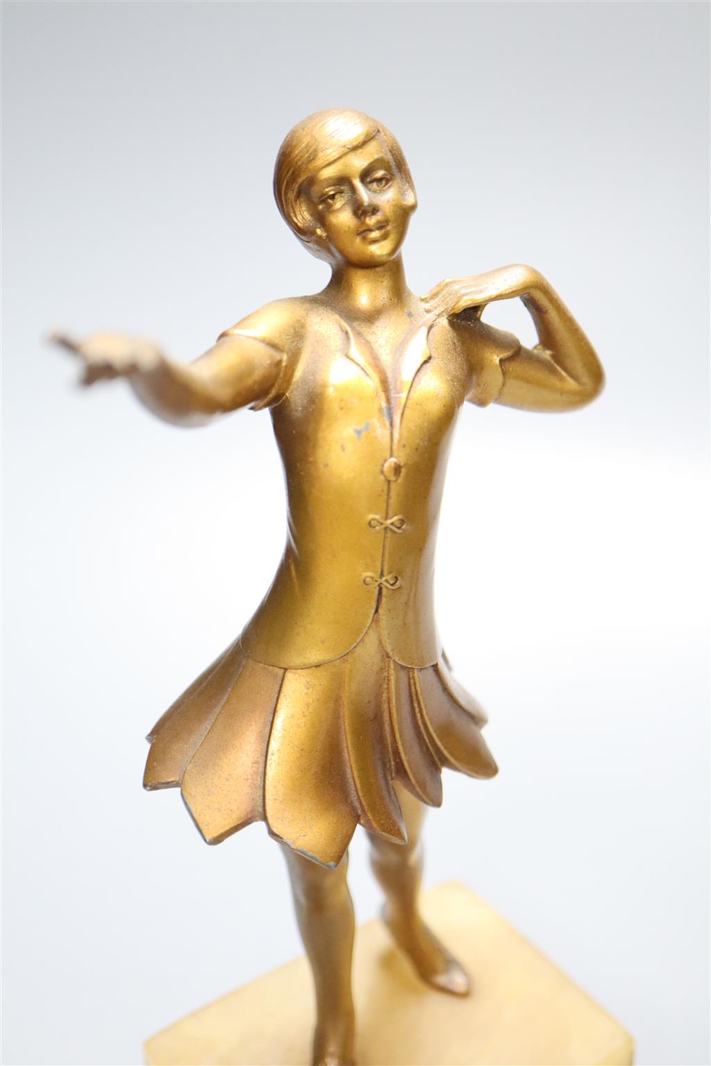 A pair of Art Deco gilt metal figures of young female dancers, on alabaster plinths, 25cm